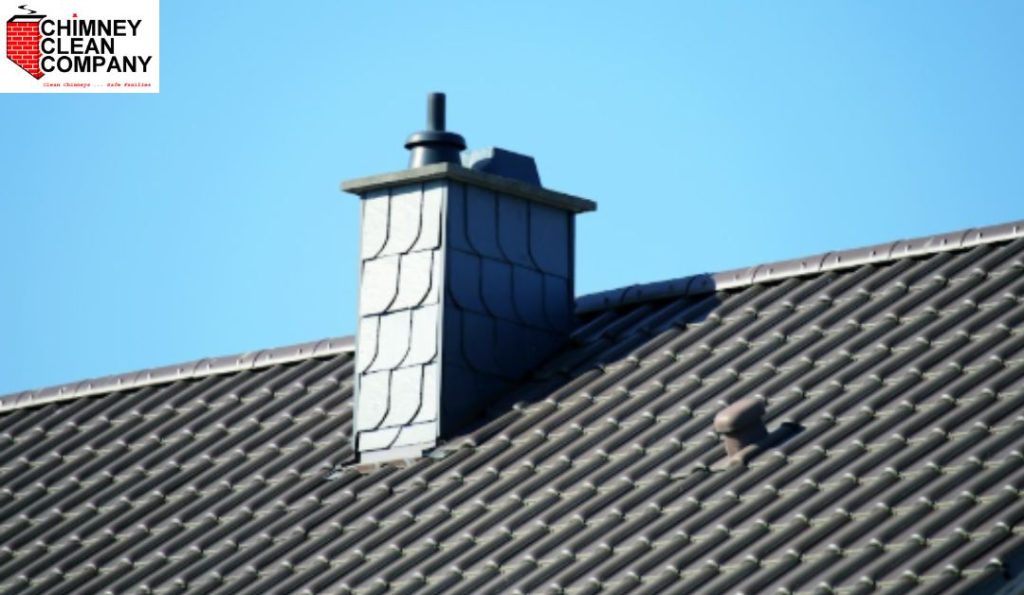 Water Damage Chimney Repair inspection showing a residential chimney on a tiled roof, highlighting the importance of identifying early signs of water damage by Chimney Clean Company, Inc.